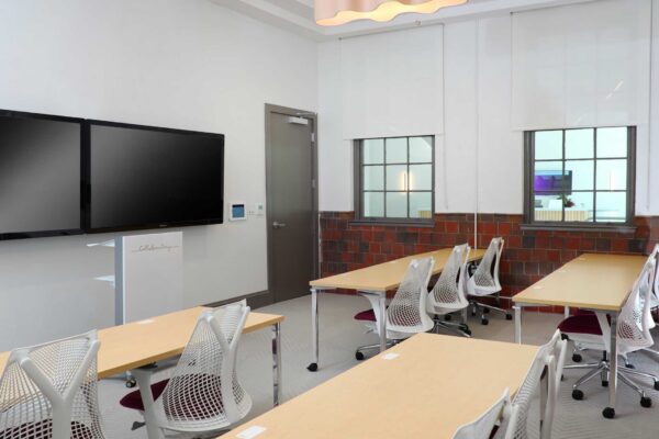 A classroom with a large tv on the wall.