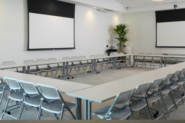 A conference room with tables and chairs.